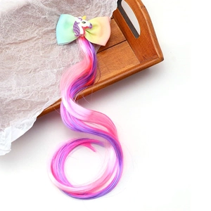 Detailed view of unicorn bow hair clip with colorful rainbow wavy hair extensions for girls