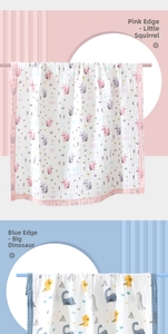 Detail of baby cotton gauze towels with pink squirrel and blue dinosaur prints
