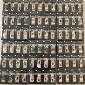 Detailed top view of various amber craft keychains featuring real insect specimens
