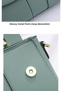 Detail of light green PU leather bag showing neat stitching and round gold metal clasp