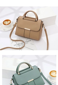 Detail of stylish matte leather flap handbag with unique semicircular metal handle
