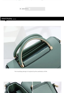 Detail view of morandi green leather bag with metal handle and smooth zipper closure