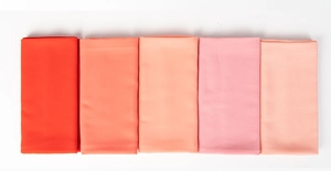 Detail view of pearl chiffon scarves in a gradient of red and pink fabric swatches