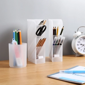 Translucent matte desk organizers with slanted compartments for stationery on a wooden desk