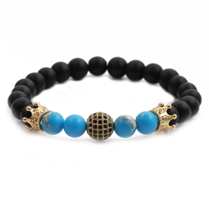 Detail of beaded bracelets with matte black onyx, blue turquoise, and gold crown charms