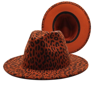 Wide brim fedora hat with orange leopard print design and black interior sweatband detail