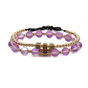 Two-piece bracelet set featuring purple matte beads and gold charms with zircon accents