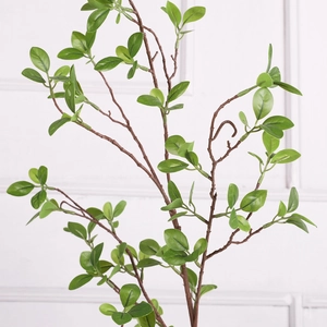 Detailed close-up of realistic green Milan leaves and textured artificial branches