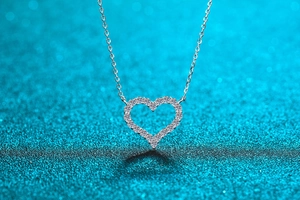 Macro shot of S925 sterling silver heart pendant necklace with shimmering moissanite