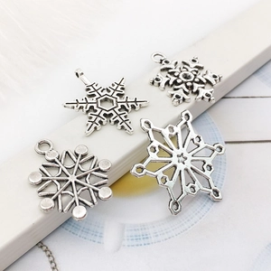 Four silver snowflake charms made of antique silver alloy for DIY jewelry bracelet making