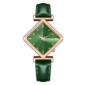 Detail showing the green diamond-shaped dial and rose gold case on a leather strap