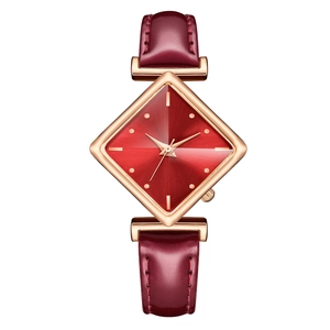Close-up of diamond-shaped watch case with red sunray dial and rose gold accents