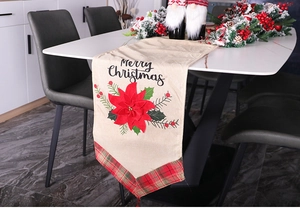 Detail of Christmas table runner with red poinsettia applique and Merry Christmas text