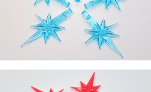 Detailed view of star-shaped transparent acrylic LED bulb covers in blue and magenta colors