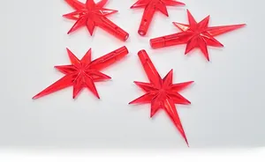 Macro view of five red translucent star-shaped LED replacement covers for ceramic Christmas trees