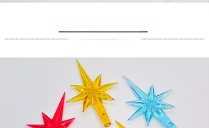 Macro view of transparent multi-faceted star-shaped LED tree toppers in various colors