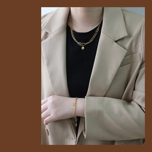 Detail of double-layered 18K gold plated titanium jewelry set with round pendants