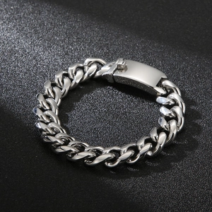 Detailed close-up of silver stainless steel Cuban link bracelet with rectangle clasp