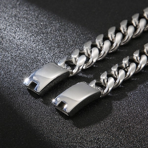 Macro detail of high-polished silver Cuban link bracelet with secure metal clasp closure