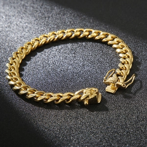 Detail shot of golden titanium Cuban link bracelet with secure side-locking buckle