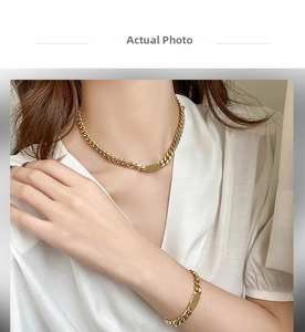 Detailed view of gold-plated thick cuban chain necklace and bracelet on model