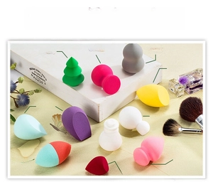 Close-up of assorted makeup sponges in various shapes and colors for face blending