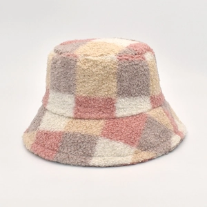 Detail of soft plaid lamb wool bucket hat featuring pink and cream checkerboard texture