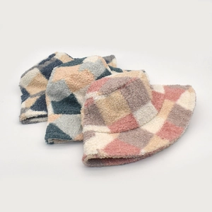 Detail of checkered sherpa bucket hats in pink, blue, and grey for autumn and winter
