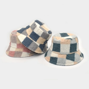 Detailed view of checkered fleece bucket hats in pink, blue, and green-orange colorways
