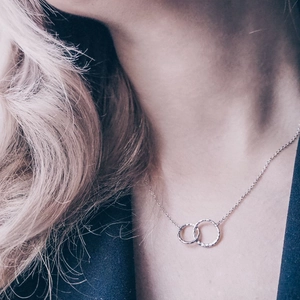 Minimalist interlocking double circle necklace with hammered texture in silver finish