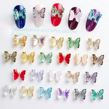 Macro shot of 3D opal butterfly nail charms with rhinestones in various vibrant colors