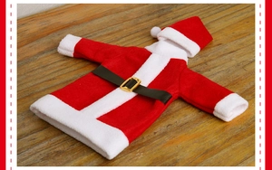 Detail of red plush Santa Claus wine bottle cover with a black belt and gold buckle