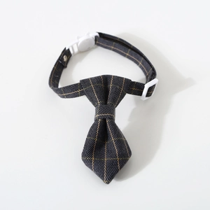 Detail view of adjustable pet collar showing gray and yellow plaid bow tie and buckle