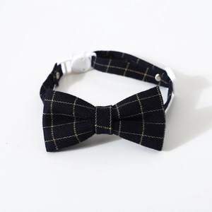 Detail of blue plaid pet bow tie collar with cat-shaped buckle and adjustable strap