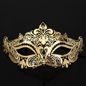 Elegant gold filigree metal masquerade mask with black gemstones for Halloween party