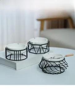 Detail of geometric metal base with white ceramic ashtray for modern home and office decor