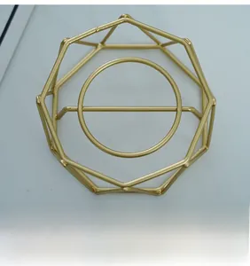 Close-up of golden geometric metal base with octagonal frame and stable center support