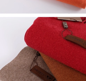 Close-up of Morandi cashmere scarves showing soft texture and premium leather labels