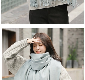 Close-up of light blue cashmere scarf showing soft knitted texture and warm fabric detail