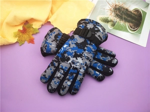 Detail of winter camouflage ski gloves with adjustable buckle straps and warm lining