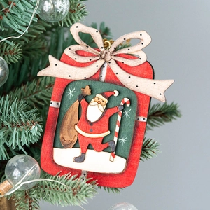 Christmas wooden Santa Claus hanging ornament with gift bag on festive tree background