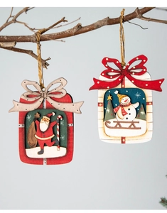 Detail of multi-layer wooden Christmas ornaments with Santa and Snowman hanging from branches