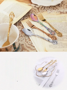 Detail of vintage embossed stainless steel dessert spoons with hollow handles in four colors