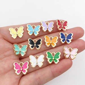 Twelve colorful enamel butterfly pendants in gold finish for DIY jewelry making and crafts
