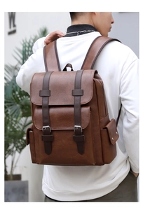 Detail view of brown PU leather backpack featuring flap cover and decorative buckles