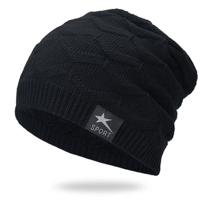 Detail of black knit beanie with diamond weave pattern and sport star patch