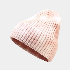 Detail of light pink chunky knit beanie showing thick ribbed texture and rolled edge cuff