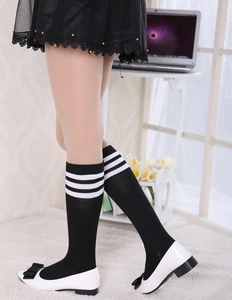 Classic black knee high socks with white triple stripes styled with schoolgirl aesthetic