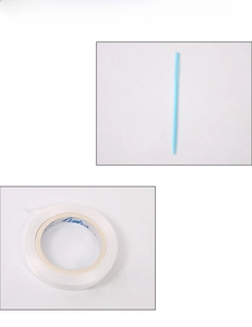 Detail of threading needle and white lanyard for banner assembly on grey background