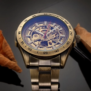 Macro detail of bronze mechanical watch with skeleton dial and tachymeter bezel